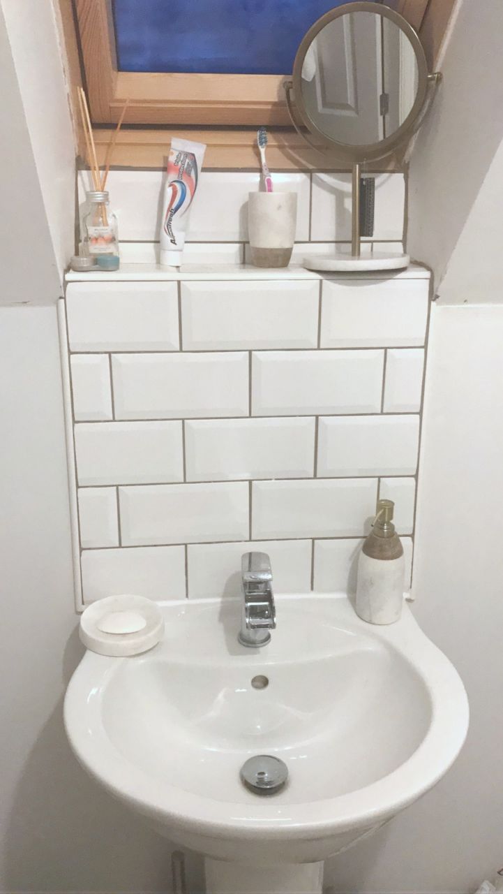Subway bathroom tiles with marble accessories