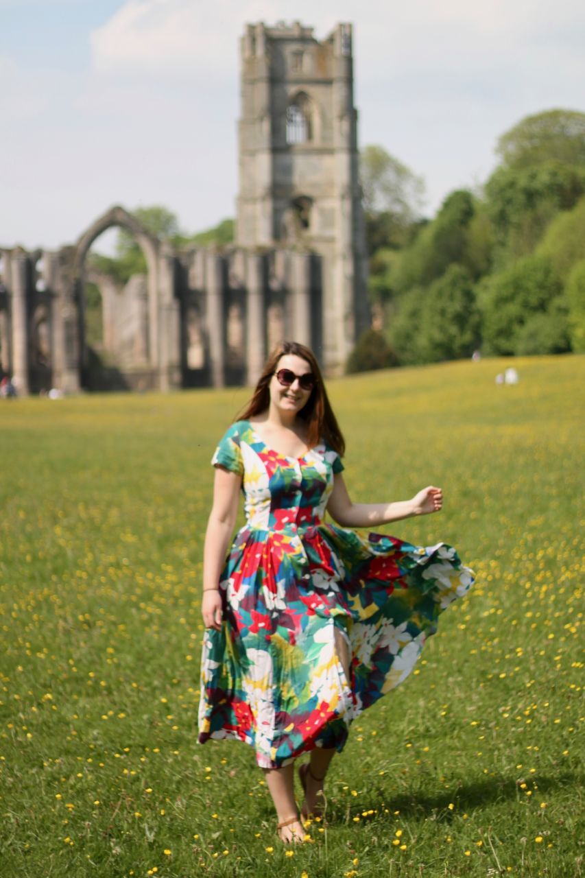 Vintage floral dress in buttercup meadow at Fountains Abbey