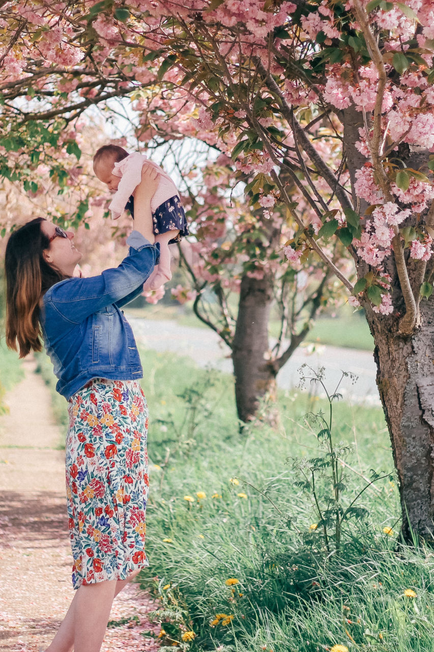 Breastfeeding outfit floral dress among the spring blossoms