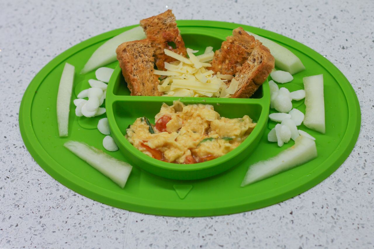 Baby led weaning breakfast - omelette with shredded cheese, toast and melon