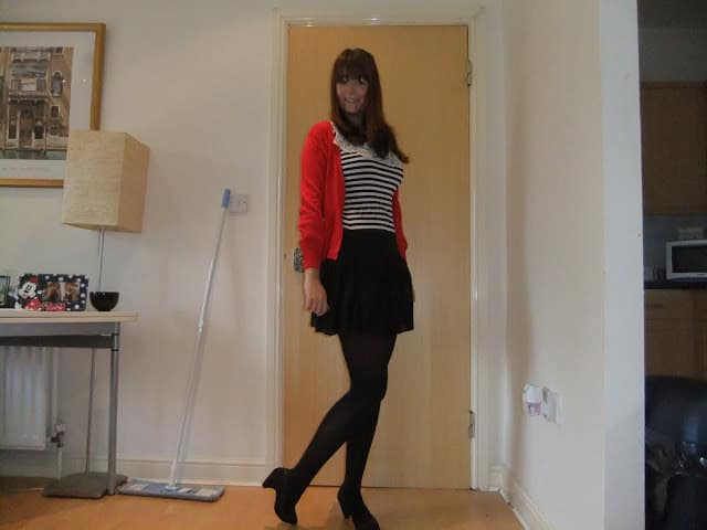 Striped top, red cardigan and black skirt