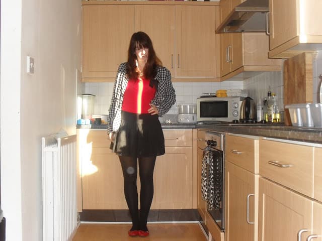 Red top, checked shirt and black skirt outfit