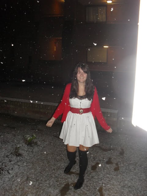 White dress with red cardigan in the snow