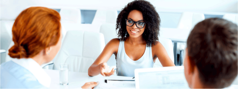 Young woman having interview with two employers